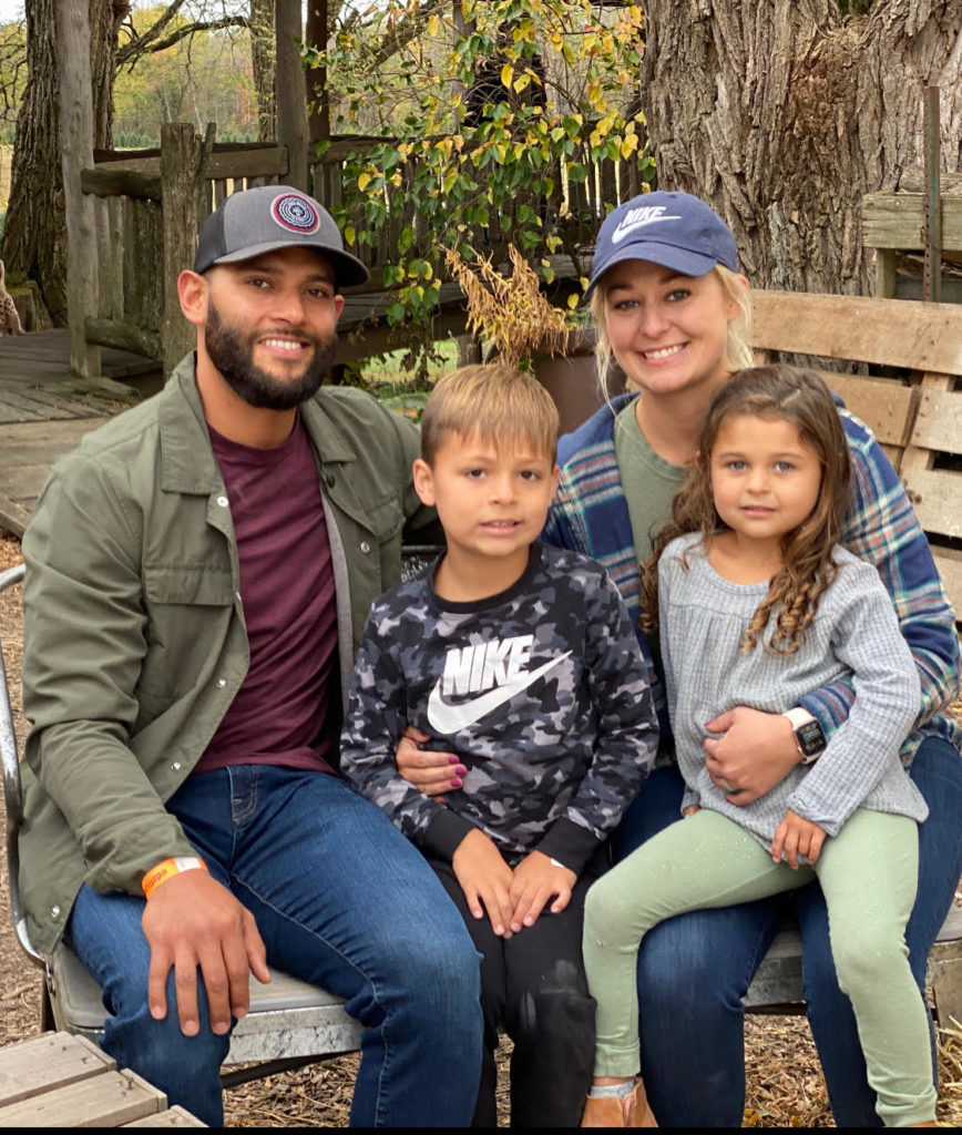 A family of four sitting together outdoors