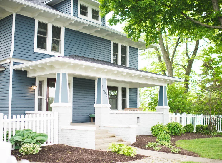 A blue house-style ABA building with a white picket fence