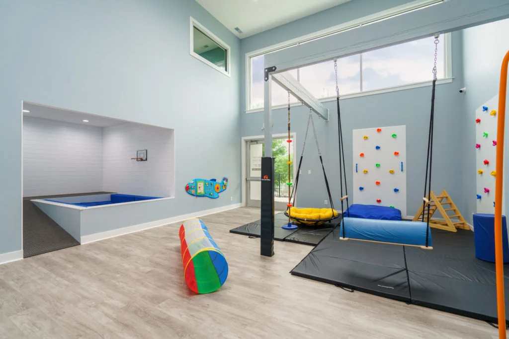 Sensory gym with swings, mats and a climbing wall