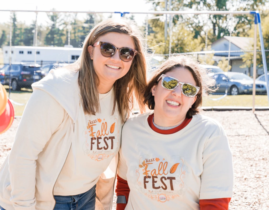 Two team members in Fall Fest shirts at the K1ds Count Therapy Fall Fest