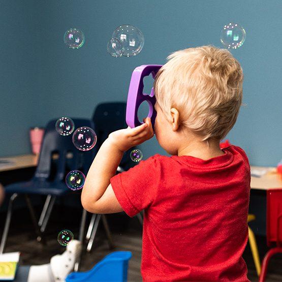 A child playing with bubbles